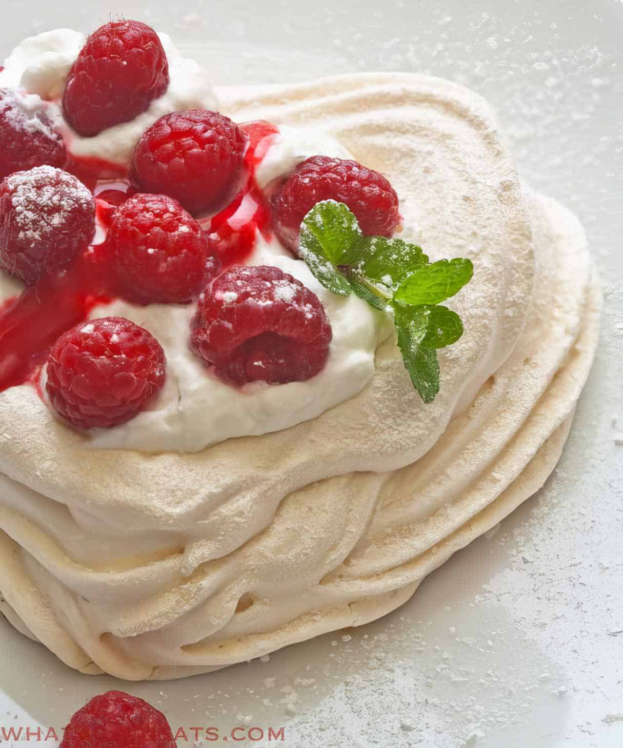 Meringue Hearts With Whipped Cream And Raspberries